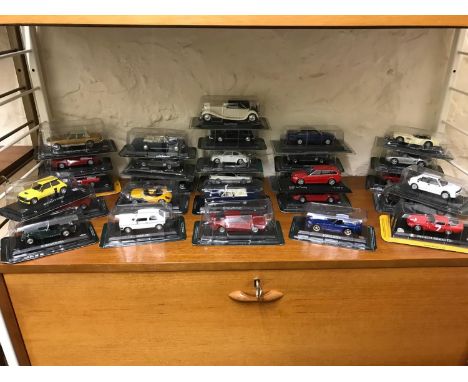 A Shelf full of boxed car models 