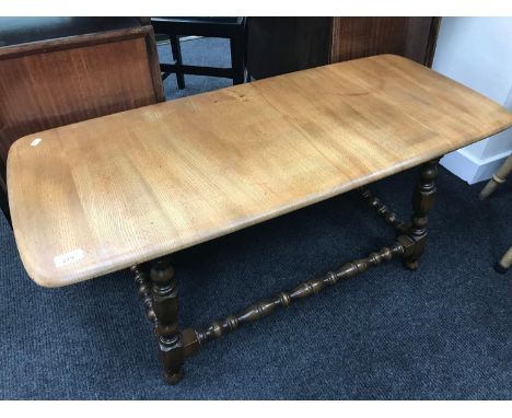 Ercol elm wood light top coffee table with dark base. 