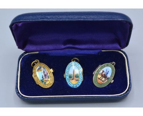 A Set of Three Enamel Pendant Lockets hand painted with oval scenes within fitted case 