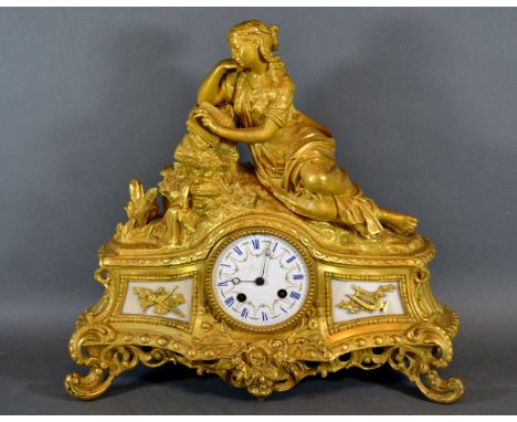 A 19th Century French Ormolu Mantle Clock, the enamel dial with Roman numerals and with two train movement and with classical