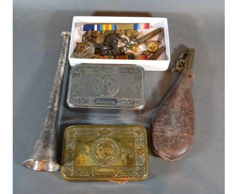 A Queen Mary Christmas Tin together with another similar leather powder flask, various cap badges and buttons, a bugle and th