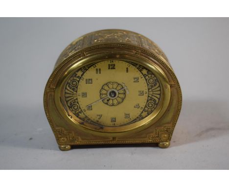 A Mid 20th Century Brass Alarm Clock with Body Decorated in Relief, Fingers Loose, Cracked Glass and Movement in Need of Atte