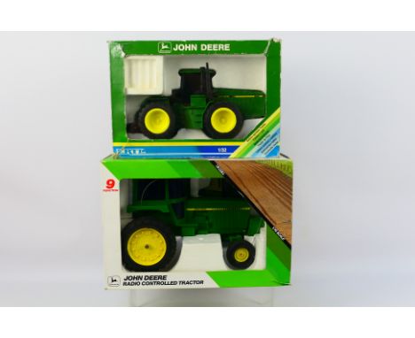 Ertl - Two boxed Ertl plastic John Deere tractors. Lot consists of a 1:16 scale radio controlled John Deere tractor; with a 1