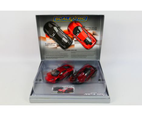 Scalextric - A boxed Scalextric Limited Edition C3171A 'McLaren MP4-12C configured by Hamilton & Button' slot car set. The tw