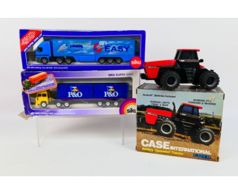 Ertl - Siku - A boxed Etl tractor with two Siku diecast model vehicles. Lot consists of Ertl battery operated Case Internatio