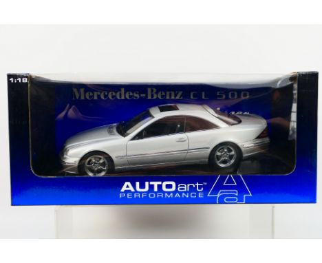 Autoart - A boxed Mercedes CL500 Lorinser version in silver # 70121. The left door mirror has come unstuck but is still in th