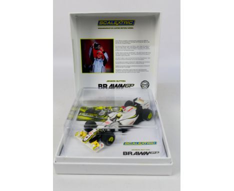 Scalextric - A boxed Scalextric Commemorative Limited Edition C3047A 'Jenson Button - Brawn BGPOO1' slot car. The model comes