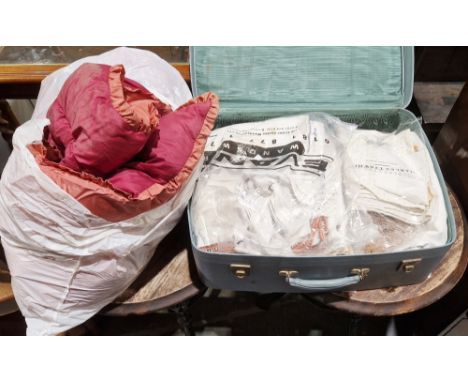 Large quantity of table linen, embroidered, a small rug, damask tablecloths&nbsp;and an eiderdown, all within a suitcase&nbsp