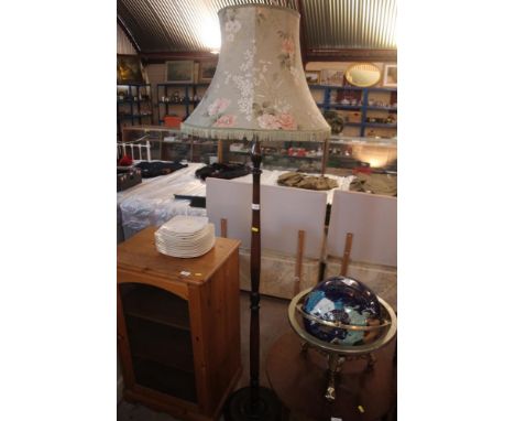 A mahogany turned column standard lamp and shade