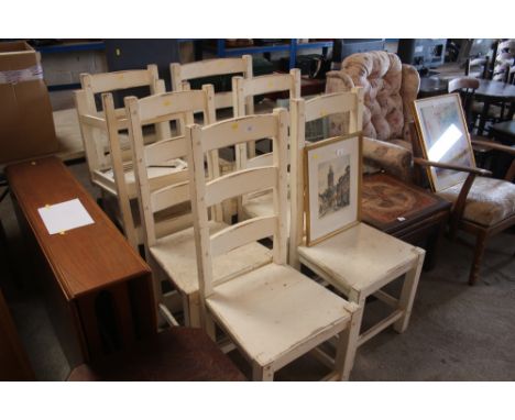 A set of seven white painted ladder back dining chairs 