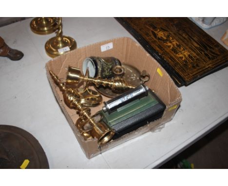 A box containing a perpetual calendar; brass candle holders; brass chamber stick; pens etc. 