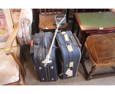 Two suitcases; and a shooting stick 