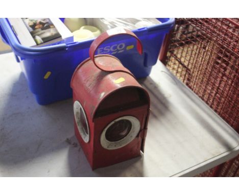 A vintage red painted traffic warning lamp