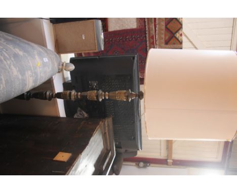 An Eastern brass standard lamp, with raised dragon decoration, complete with shade