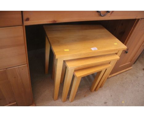 A nest of three light oak effect occasional tables 