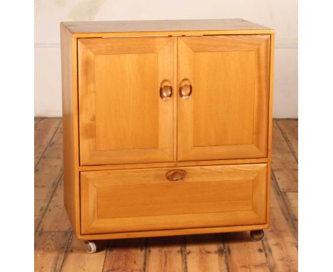 An Ercol blonde elm Windsor cupboard, on castors, h.94 x 51 x 85cm