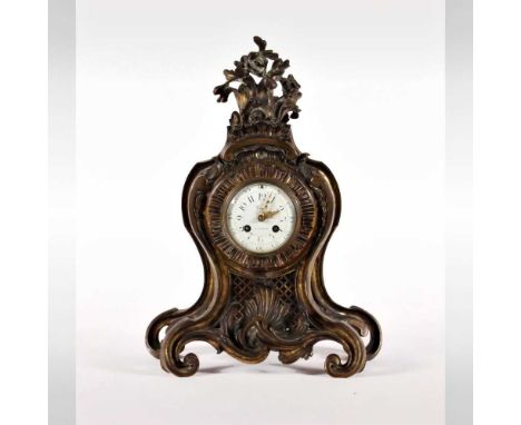 A Rococo style gilt bronze mantel clock, 19th century, the white enamel dial signed 'Viger a Paris', having an eight day move
