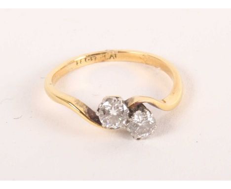 An 18ct gold two-stone diamond crossover ring, 2.7g, size K/L