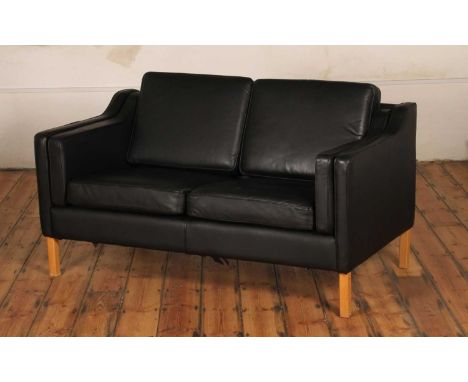 In the manner of Borge Mogensen, a Danish black leather sofa, 81 x 140 x 78cm