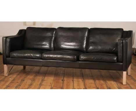 In the manner of Borge Mogensen, a Danish black leather three-seater sofa, 81 x 214 x 82cm