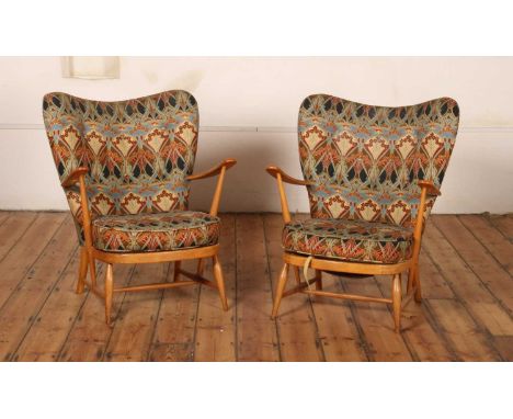 A pair of Ercol blonde elm Windsor armchairs, each having Art Nouveau style upholstery, h 85cm, w 73cm, d 50cm, Seat Height -