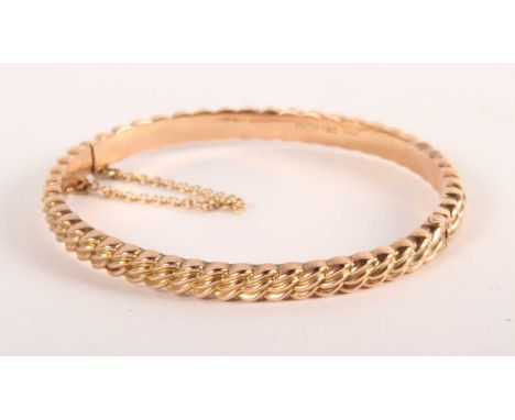 A 9ct gold hinged bangle, 7.74g