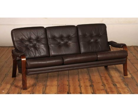 A Danish brown leather button upholstered three-seater sofa, having a bentwood frame, 72 x 177 x 78cm