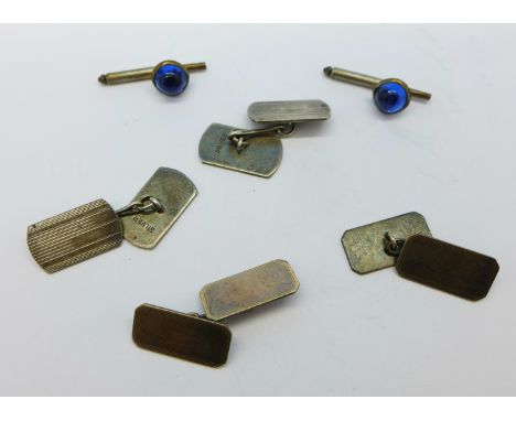 Three pairs of cufflinks, one silver, one white metal and one blue stone