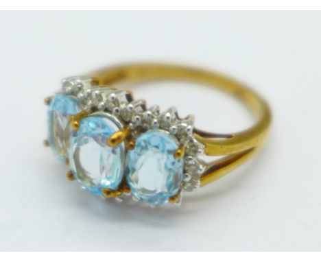 A 9ct gold ring set with three blue topaz and diamonds, 4g, P