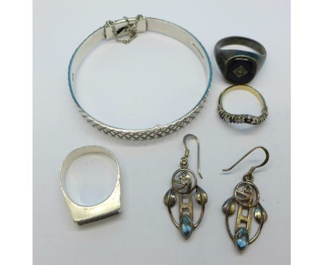 A silver bangle, three silver rings and a pair of Arts and Crafts style earrings, 37.9g
