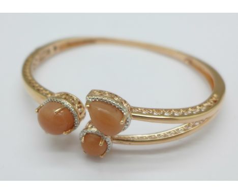 A silver gilt and pink sunstone bangle