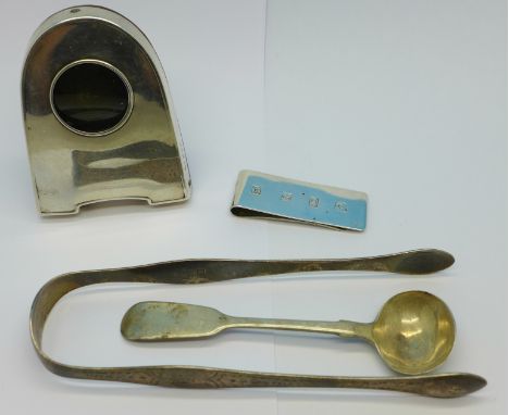 A silver money clip, clock frame, sugar bows by Peter & William Bateman and a Victorian mustard spoon