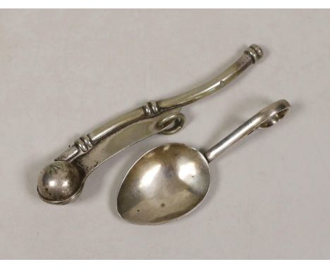 A George V silver caddy spoon and a plated bosun’s whistle.