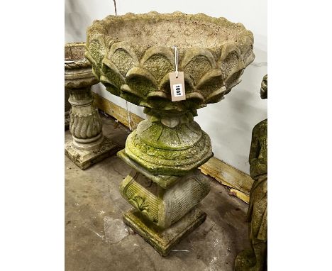 A reconstituted stone circular garden planter on square plinth, diameter 52cm, height 89cm