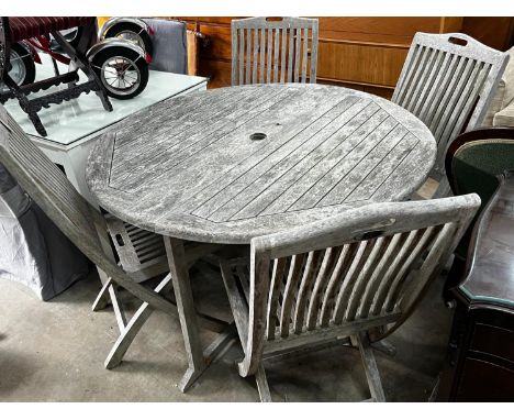 A Jo Alexander circular weathered teak folding garden table, diameter 120cm, height 75cm and four chairs