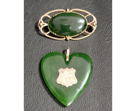 JADE HEART SHAPED PENDANTwith central nine carat gold panel and suspension loop, approximately 4cm high; and a jade coloured 