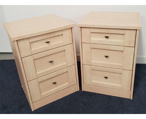 PAIR OF LIGHT OAK BEDSIDE CHESTSwith square tops above panelled drawers, standing on a plinth base, 71cm high (2) 