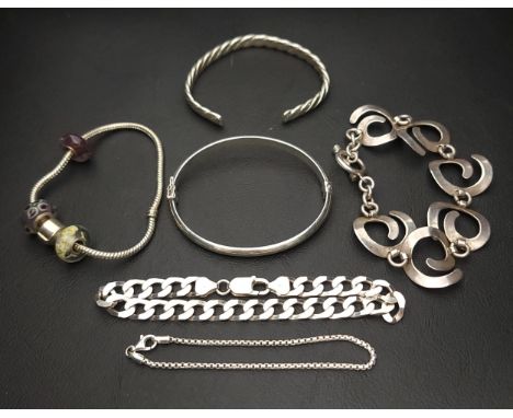 SELECTION OF SILVER BRACELETS including chain bracelets, one with spiral links, a Pandora style bracelet with charms, a cuff 