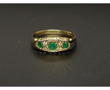 GRADUATED EMERALD AND DIAMOND CLUSTER RINGthe three round cut emeralds totalling approximately 0.25cts interspersed with four