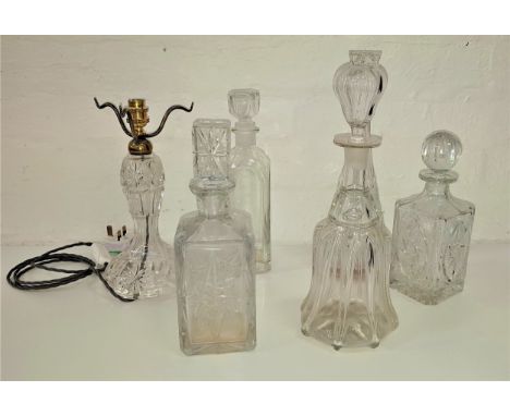 EDWARDIAN CUT GLASS TABLE LAMP AND FIVE DECANTERSthe lamp raised on a circular base. 28cm high, together with five glass deca