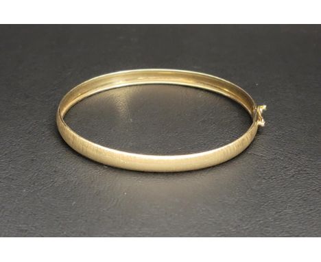 FOURTEEN CARAT GOLD BANGLE with a brushed finish and safety claspapproximately 4.2 grams 