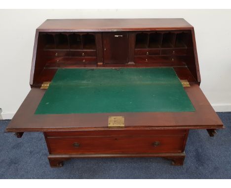 GEORGE III MAHOGANY BUREAUwith a baize lined fall flap and a fitted interior of a cupboard, pigeon holes, drawers and two sec