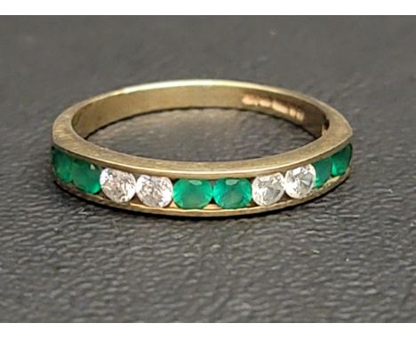 GREEN AND CLEAR STONE SET HALF ETERNITY RINGin nine carat gold, ring size N-O 