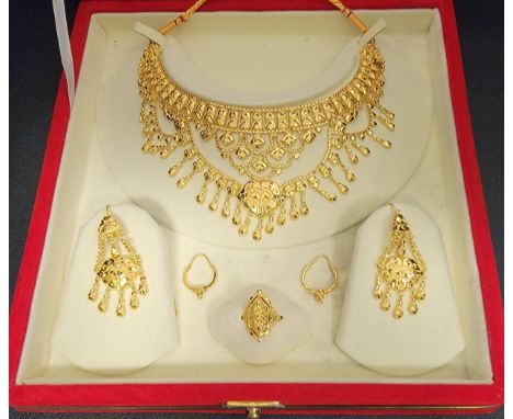 UNMARKED HIGH CARAT GOLD SUITE OF INDIAN WEDDING JEWLLERYcomprising two sets of earrings, a ring and a necklace with floral m