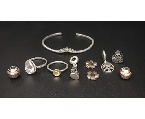 SELECTION OF PANDORA JEWELLERYcomprising a Barcelona La Sagrada Familia Dangle charm, a Sparkling Teardrop Halo ring, a Novem