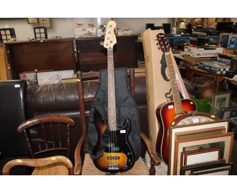 A Squier by Fender precision bass electric guitar in case