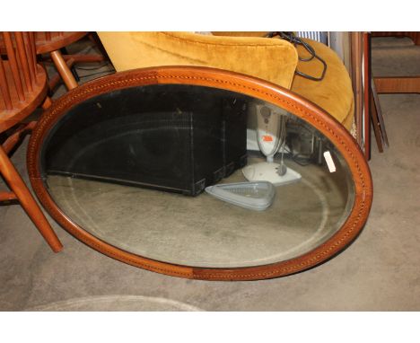 A mahogany and inlaid bevel edged wall mirror