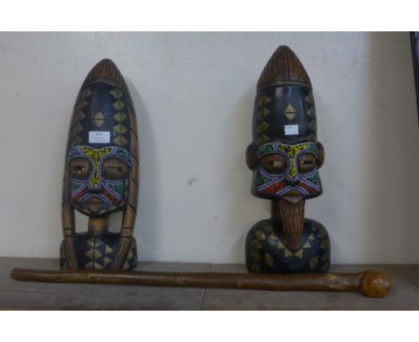 A pair of painted carved wooden African busts and a knobkerrie 