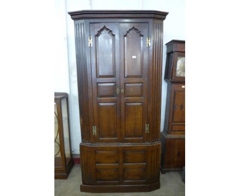 A George III oak architectural freestanding corner cupboard 
