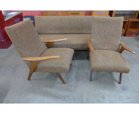 A Greaves &amp; Thomas teak and fabric upholstered three piece lounge suite, comprising a sofa/daybed and pair of armchairs. 